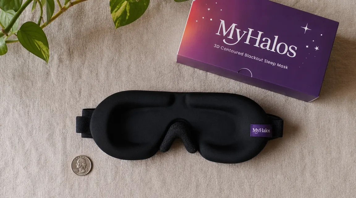 MyHalos sleep mask laid flat next to a coin for scale, showing the nose bridge foam detail